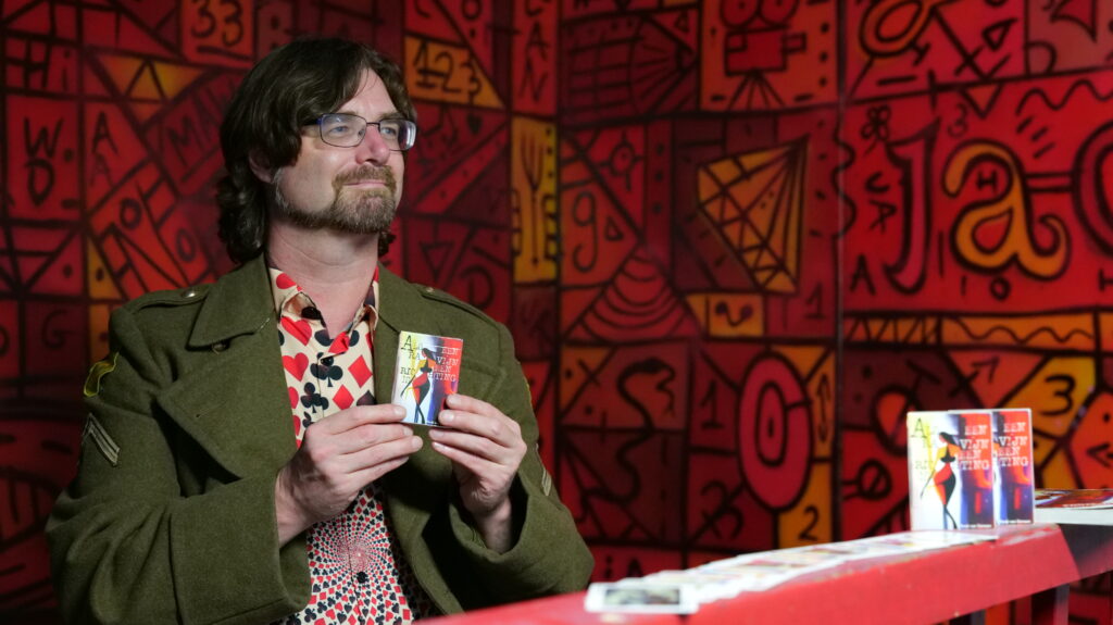 René van Densen met zijn dichtbundel kaartset "Als Een Ravijn Een Richting Is"